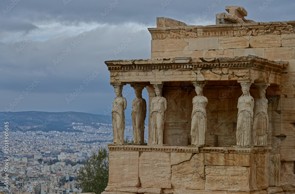 Obraz premium Ancient Erechtheion Temple on the Acropolis of Athens Under Dramatic Storm Clouds, Greece