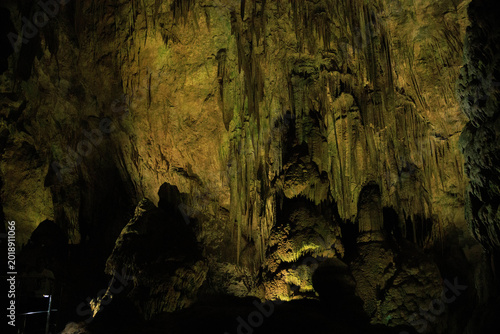 Bild auf Leinwand Dramatic limestone cave interior featuring impressive stalactites and stalagmites formed over thousands of years