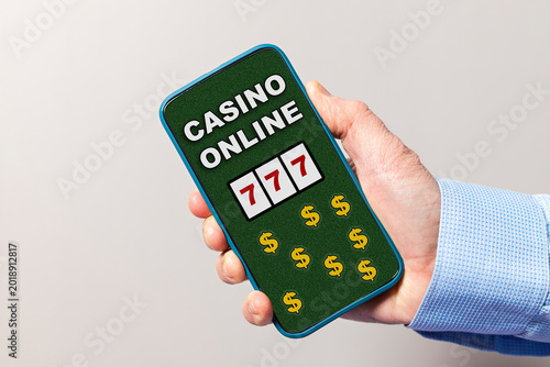 Hand holding smartphone playing casino online slots for jackpot