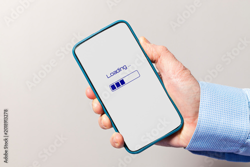 Hand holding smartphone displaying loading progress bar