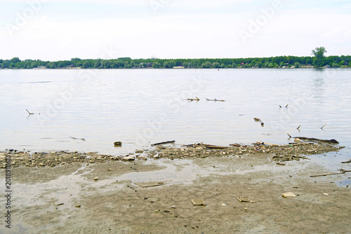 Photography Exposed mudflats along Danube shoreline under pale overcast sky in Serbia