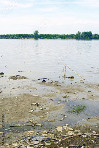 Fényképezés Danube with driftwood and muddy sediment exposed beside retreating waterline