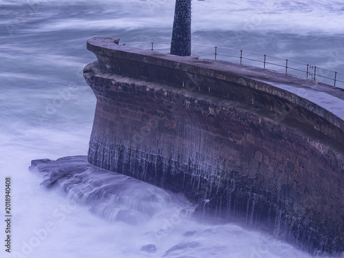 Fotografija Seawall protecting coast from powerful ocean waves