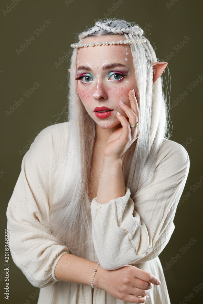 Fototapeta premium Beautiful elf girl on dark olive background