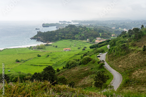 Toranda Beach coastline with green hills and calm waves