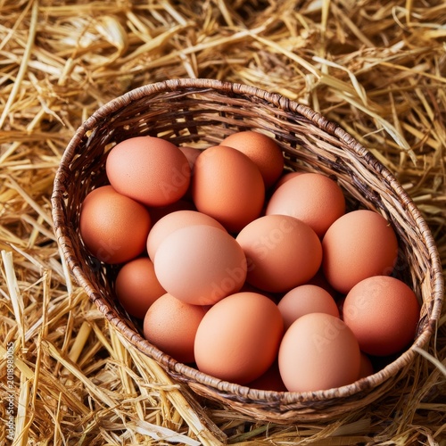 Basket Filled With Fresh Eggs Resting on Straw in a Rustic Setting