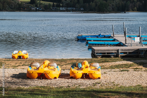 Yellow pedal boats parked on lakeside beach