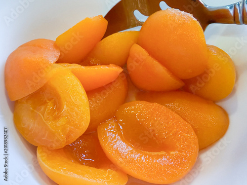 Preserved Apricot Halves with Syrup and Serving Spoon