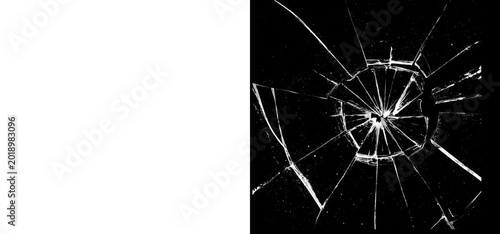A closeup view of a shattered glass surface with sharp cracks and broken pieces on a dark background isolated on transparent background