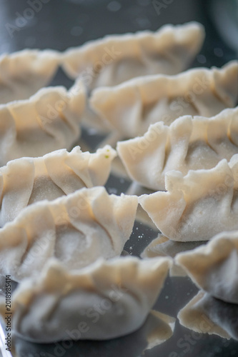 High angle shot of handmade Chinese Jiaozi dumplings, gluten-free version, authentic Asian cuisine