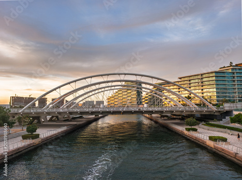 Modern Bridge Over Waterway at Al Raha Beach, Abu Dhabi, UAE During Sunset