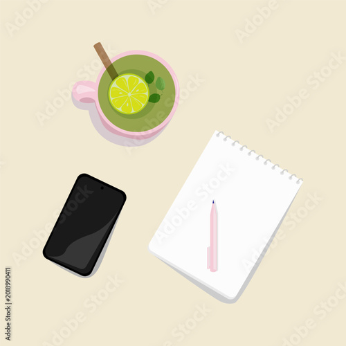 On the desktop, there is a pink cup with healthy green tea with lemon, a notebook, a pen, and a phone. Learning concept, working from home