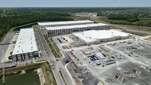 Aerial view of large industrial warehouses and construction site at Saint Johns Parkway and International Golf Parkway in World Golf Village, Florida, United States.