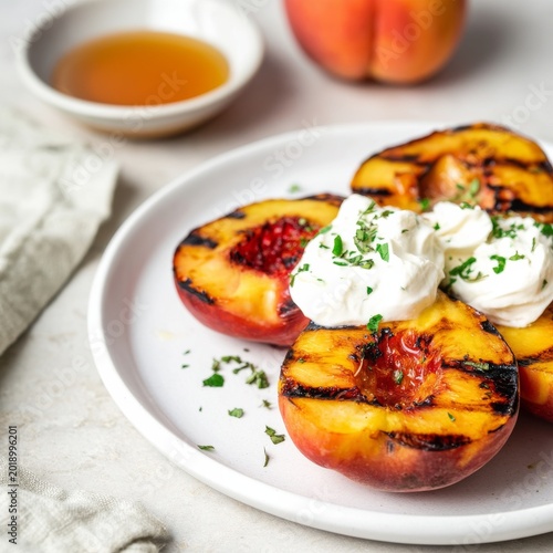 Grilled Peaches With Honey and Cream Served on a Plate With Herbs