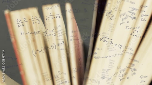 Camera pulling back, two open books fanning pages, revealing math notation for study visualization