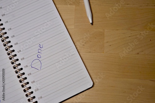 Job done message handwritten on a notebook with pen. Tasks to be done finished job productivity project chores