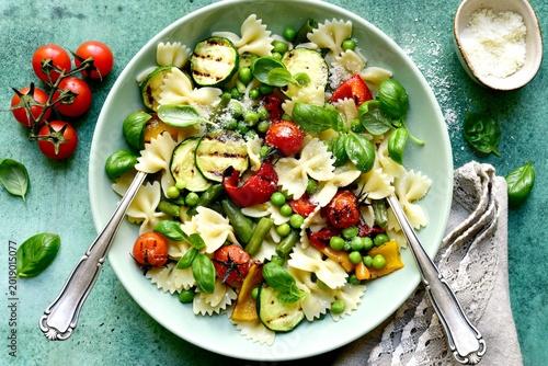 Traditional italian pasta primavera with spring vegetables. Top view with copy space.