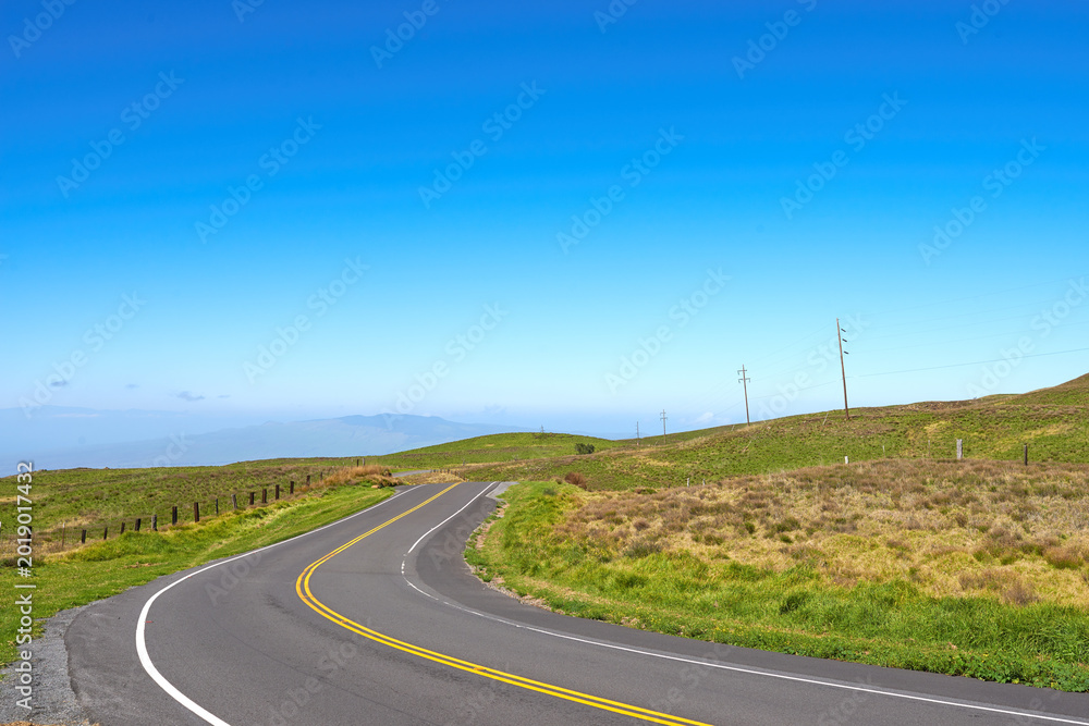 Obraz premium Empty, blue sky and road in countryside for travel, tourist destination and journey outdoor. Landscape, background and street with scenic route, highway or mockup space for vacation, trip and holiday