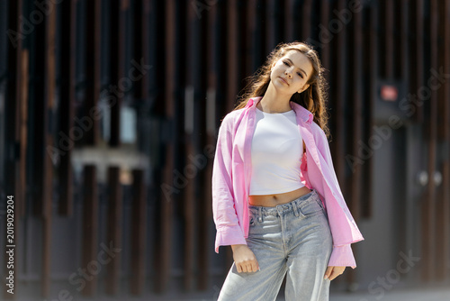 Young woman posing in casual street fashion style
