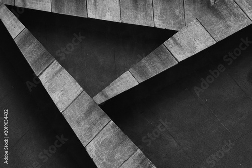 Abstract minimalist architectural composition featuring intersecting concrete lines, geometric shapes, negative space. Contemporary urban design