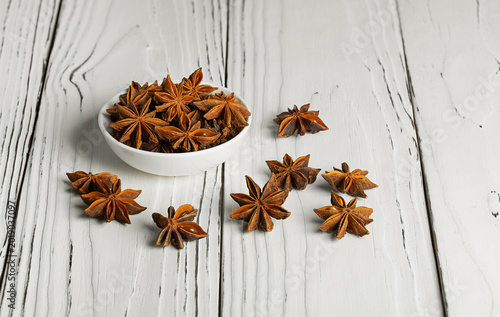 Konstfotografi Star anise, or badian, is a star-shaped fruit with seeds inside, on a white back