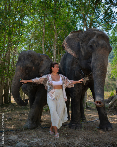 Sticker One woman with two elephants in Thailand, in the middle of the forest