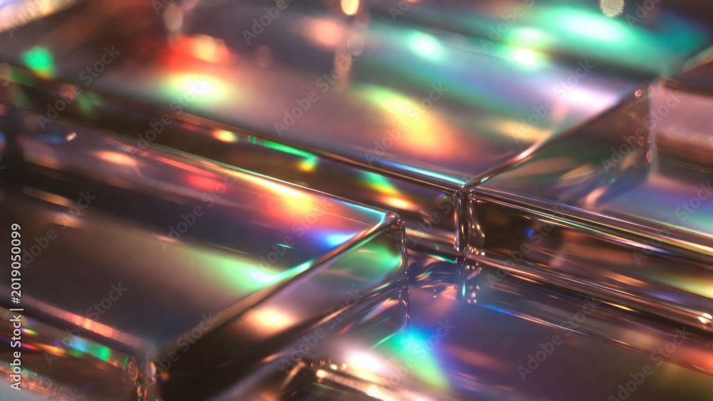 Fototapeta premium Stacked glass tiles scattering colorful light on reflective surface