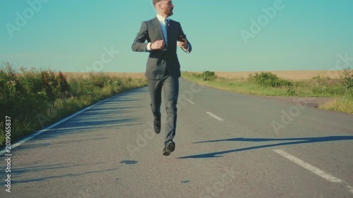 Professional swiftly marches along rural path, Individual dressed formally accelerates on country road urgently