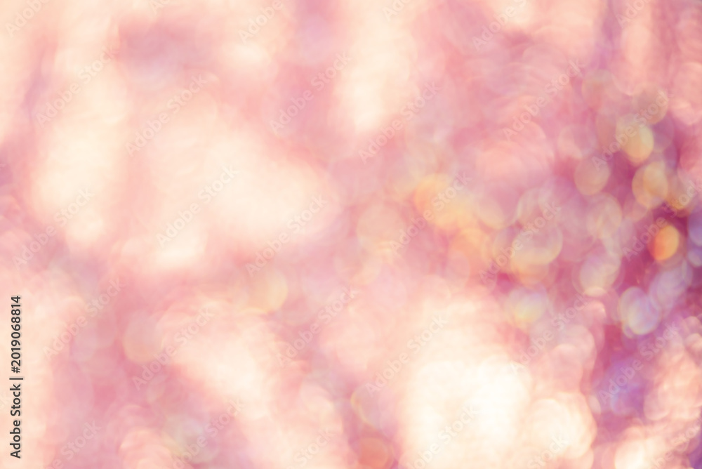 Fototapeta premium Defocus light background pink with yellow. Blurred sparkles