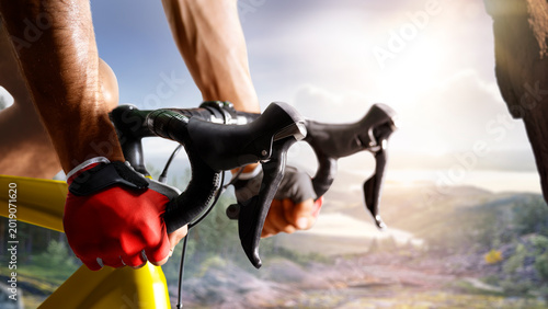Cycling. A captivating shot of a helmeted biker riding along an asphalt road. Cycling competitions. Active recreation. Sport. Professional road bicycle racer close up view
