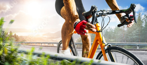 Cycling. A captivating shot of a helmeted biker riding along an asphalt road. Cycling competitions. Active recreation. Sport. Professional road bicycle racer close up view