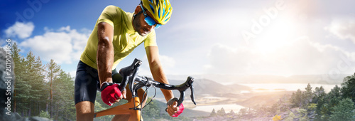 Cycling. A captivating shot of a helmeted biker riding along an asphalt road. Cycling competitions. Active recreation. Sport. Professional road bicycle racer close up view