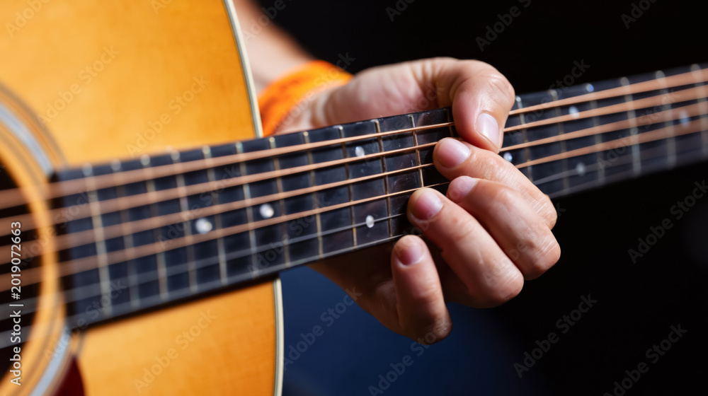 Obraz premium Acoustic guitar performance with detailed fingerpicking technique at live show