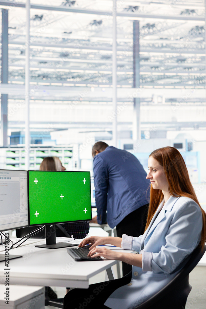 Naklejka premium Green screen computer, analyzing microchips layout and woman in RD office. Doing innovative study, mockup PC program and female engineer researching materials for nanotechnology development