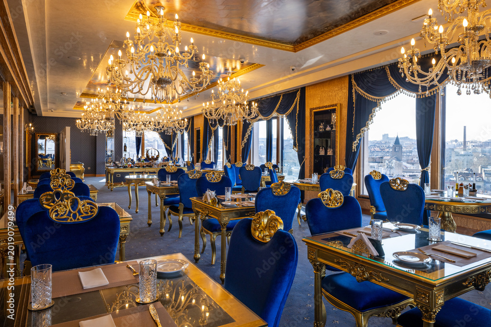 Fototapeta premium Grand luxury ballroom restaurant with crystal chandeliers and blue royal decor
