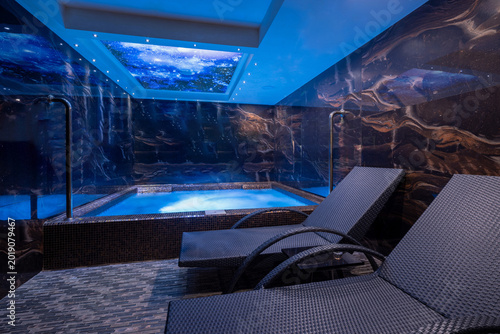 Indoor luxury pool and jacuzzi area with starry sky ceiling design