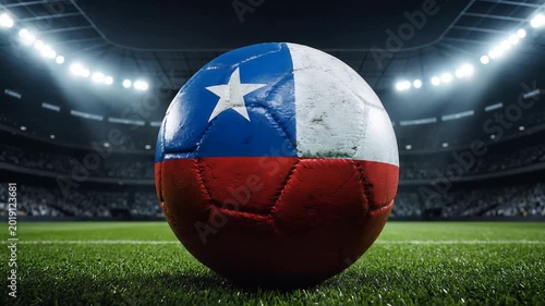 Chilean flag soccer ball, seamlessly rotating on a vibrant green grass pitch in a cinematic stadium, under dramatic night floodlights with a cheering crowd, representing national pride and sports