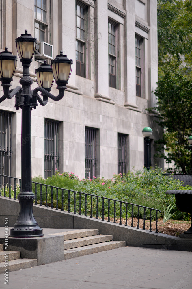 Fototapeta premium Contemporary Public Building Featuring Detailed Lampposts And Stone Steps new york
