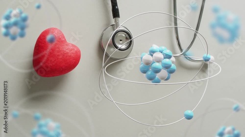 Molecular clusters appearing above stethoscope, orbiting and rotating, visualizing health concept