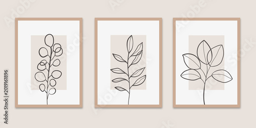 Bild auf Leinwand Set of three minimalist botanical wall art prints featuring black continuous line drawings of leaves and branches on beige rectangular backgrounds with thin tan frames in a triptych layout