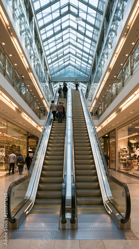 Modern Retail Experience: Shopping Mall Escalator Under Glass Roof in Urban Lifestyle Hub