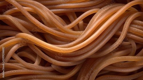 Close-Up View of Wavy Brown Pasta Strands on a Dark Background Highlighting Texture and Shape for Culinary Imagery and Food Presentation