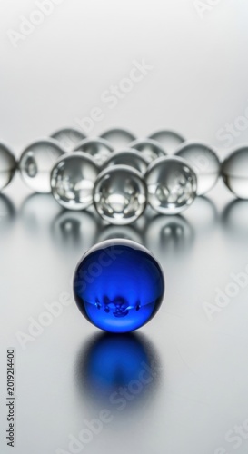 Blue glass marble, standing out from crowd, leadership concept, business metaphor
