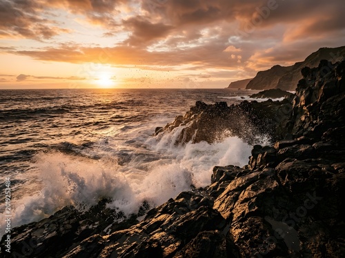 Dramatic sunset over a rugged volcanic coastline with powerful ocean waves crashing against dark rocks
