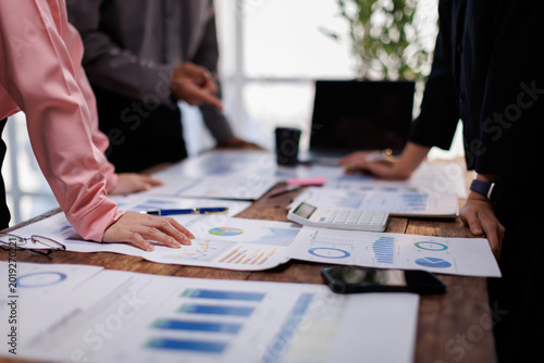 Asian business adviser meeting to analyze and discuss the situation on the financial report in the meeting room.Investment Consultant, Financial advisor and accounting concept