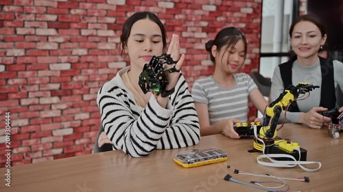 Female Teacher And Young Student Build Robotic Arm In STEM Science Class
