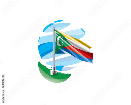 Tableau sur toile Comoros flag on a green lawn against a background of blue abstract sky