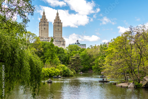 Row boats in lake in Central Park with Eldorado building in distance, Manhattan, New York city, USA