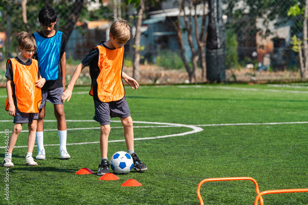 Obraz premium World cup concept with soccer ball or football player, youth soccer drill on green field with children practicing footwork and ball control