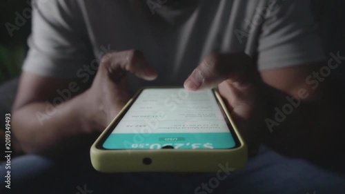 Person checking bank account balance on smartphone